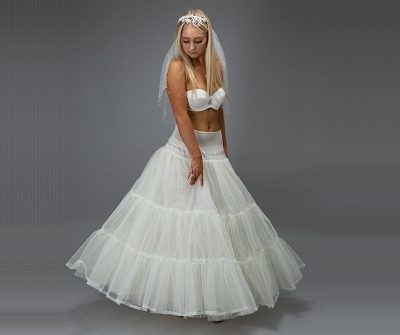 bride in a white petticoat looking down