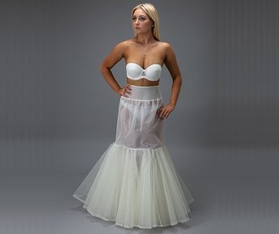 bride in a white petticoat with hand on hip